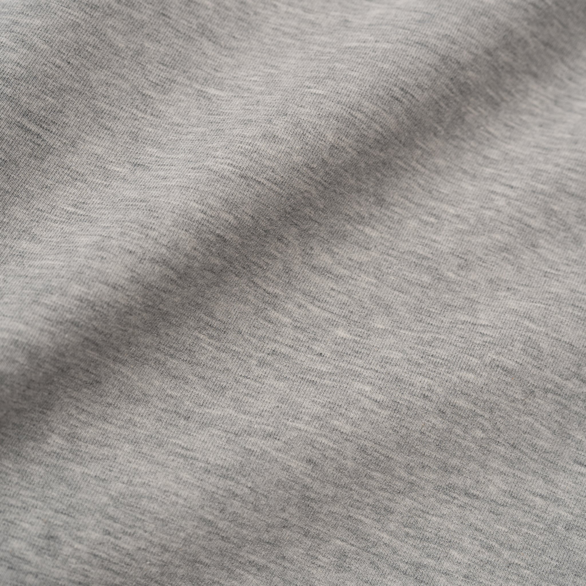 Close-up of heather grey Pima cotton fabric texture.